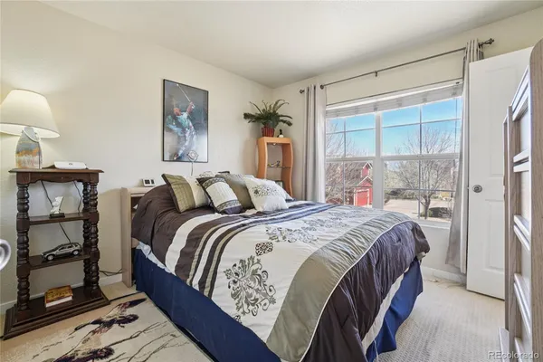a bedroom with bed and wooden floor