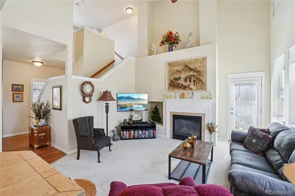 a living room with furniture and a fireplace
