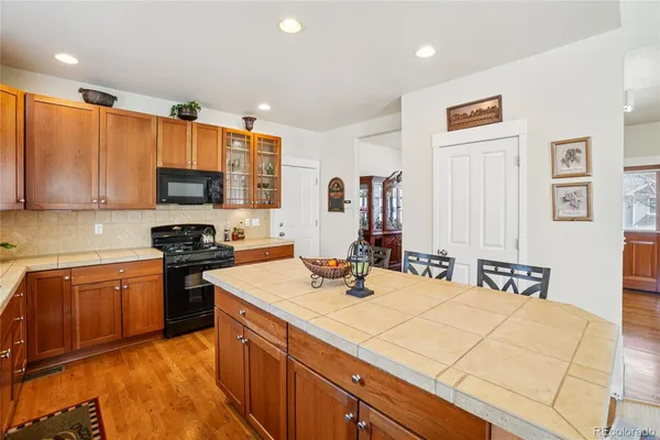 a kitchen with a sink appliances and cabinets