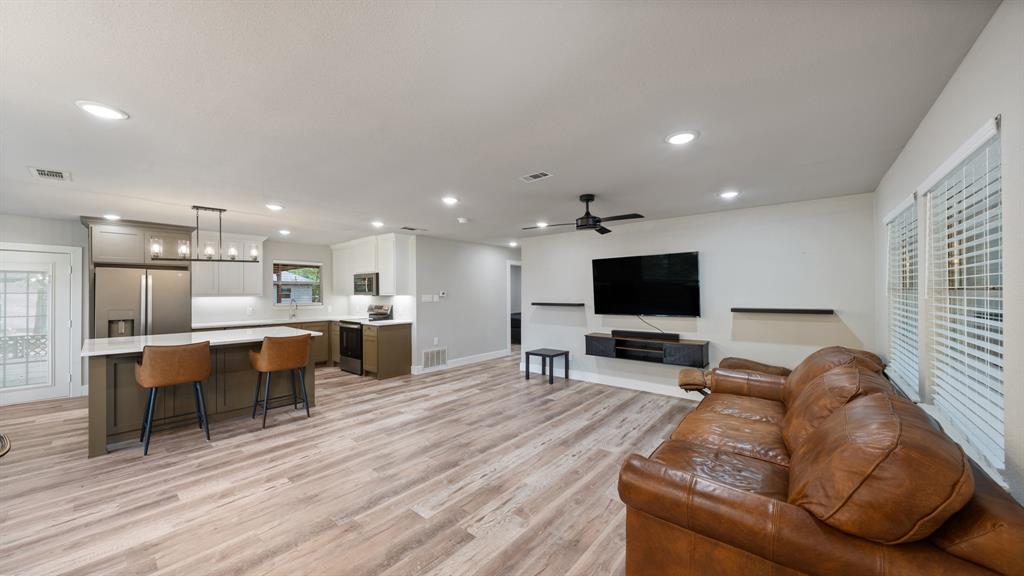129 King Arthur Road Mabank, TX 75156 - Photo 27 of 33 a living room with furniture kitchen view and a flat screen tv