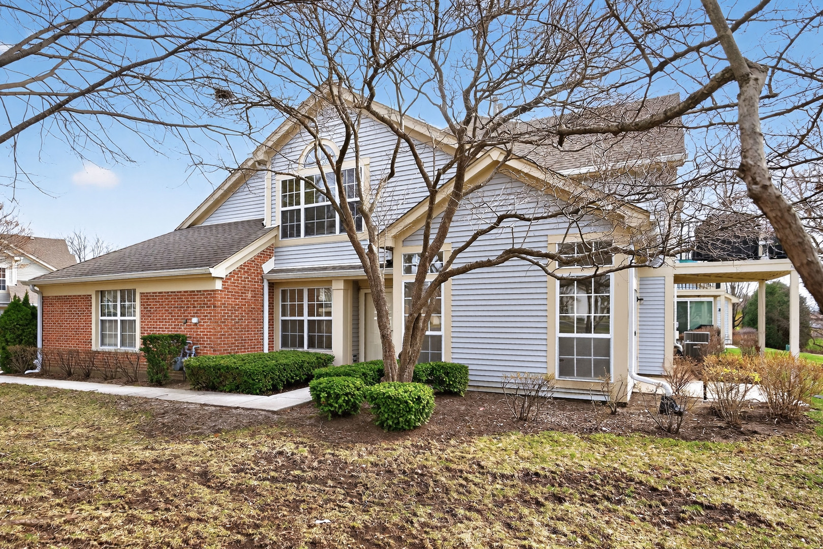 446 Cromwell Circle, Unit 4 Bartlett, IL 60103 - Photo 1 of 18 a front view of a house with a yard