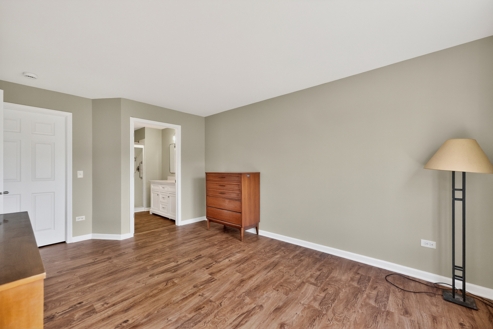 446 Cromwell Circle, Unit 4 Bartlett, IL 60103 - Photo 11 of 18 an empty room with wooden floor and cabinet