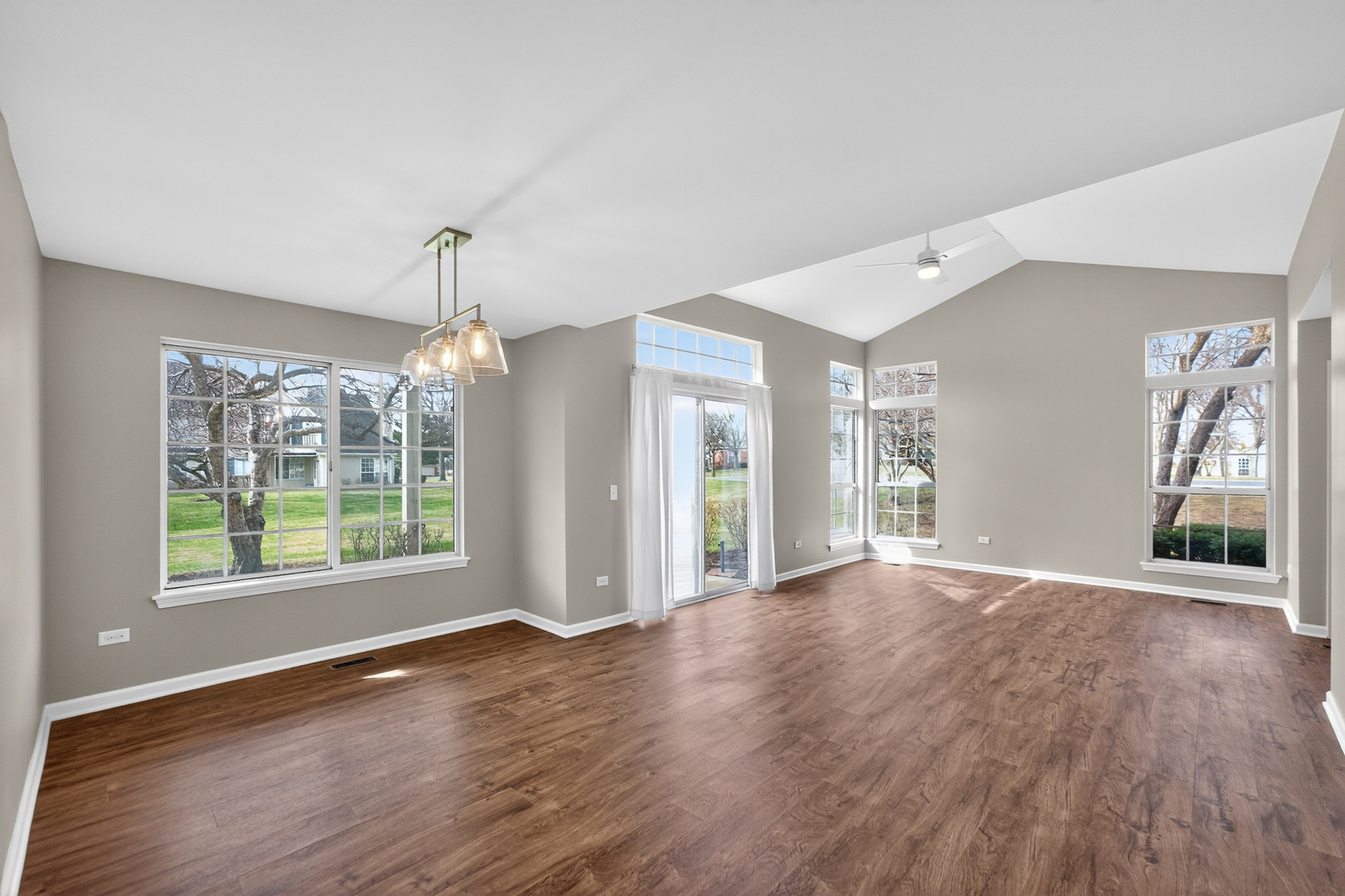 446 Cromwell Circle, Unit 4 Bartlett, IL 60103 - Photo 5 of 18 a view of an empty room with wooden floor and a window