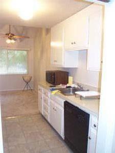 255 South Rengstorff Avenue, Unit 94 Mountain View, CA 94040 - Photo 7 of 12 a kitchen with a stove and a sink
