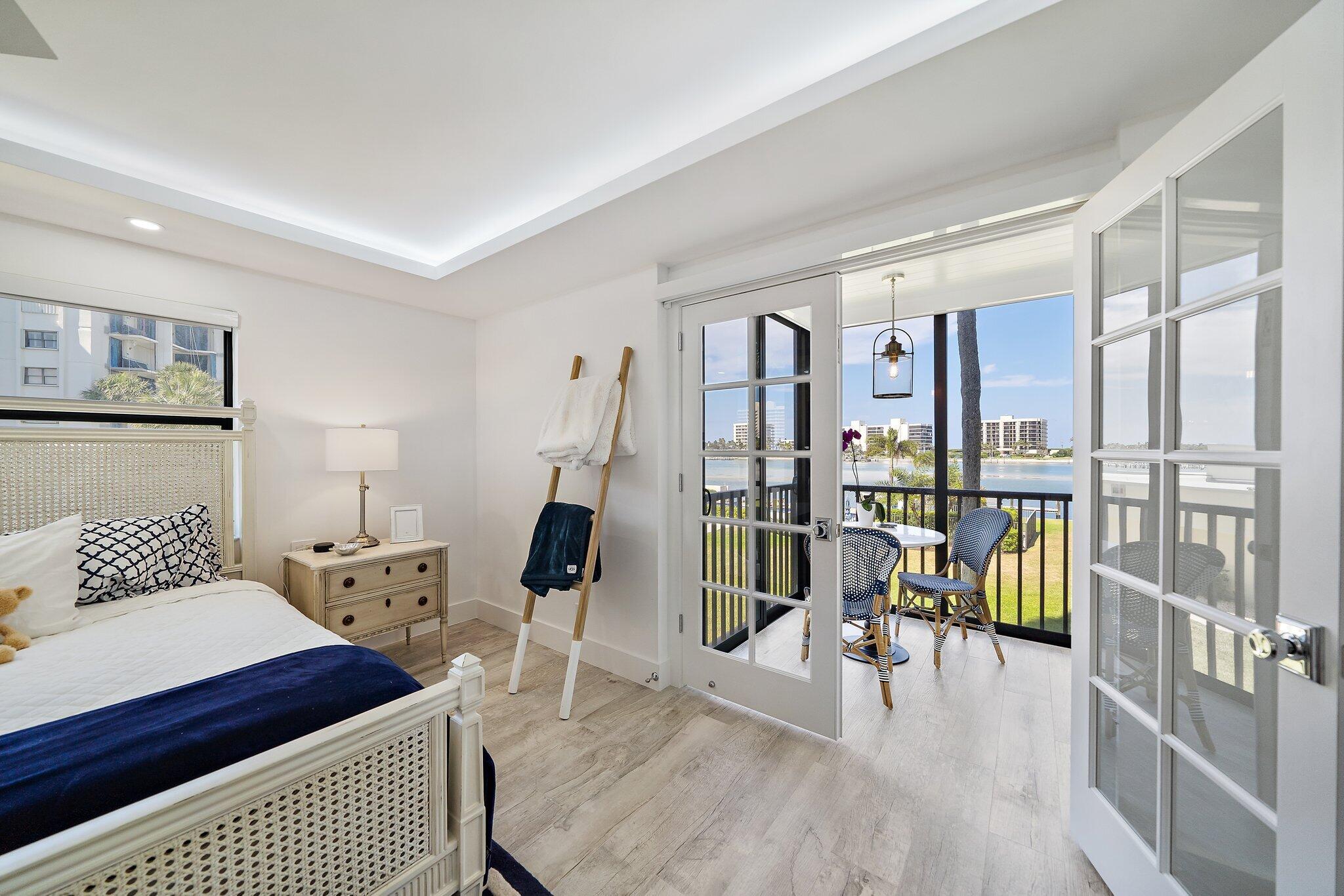 19800 Sandpointe Bay Drive, Unit 210 Jupiter, FL 33469 - Photo 13 of 59 a bedroom with furniture and wooden floor