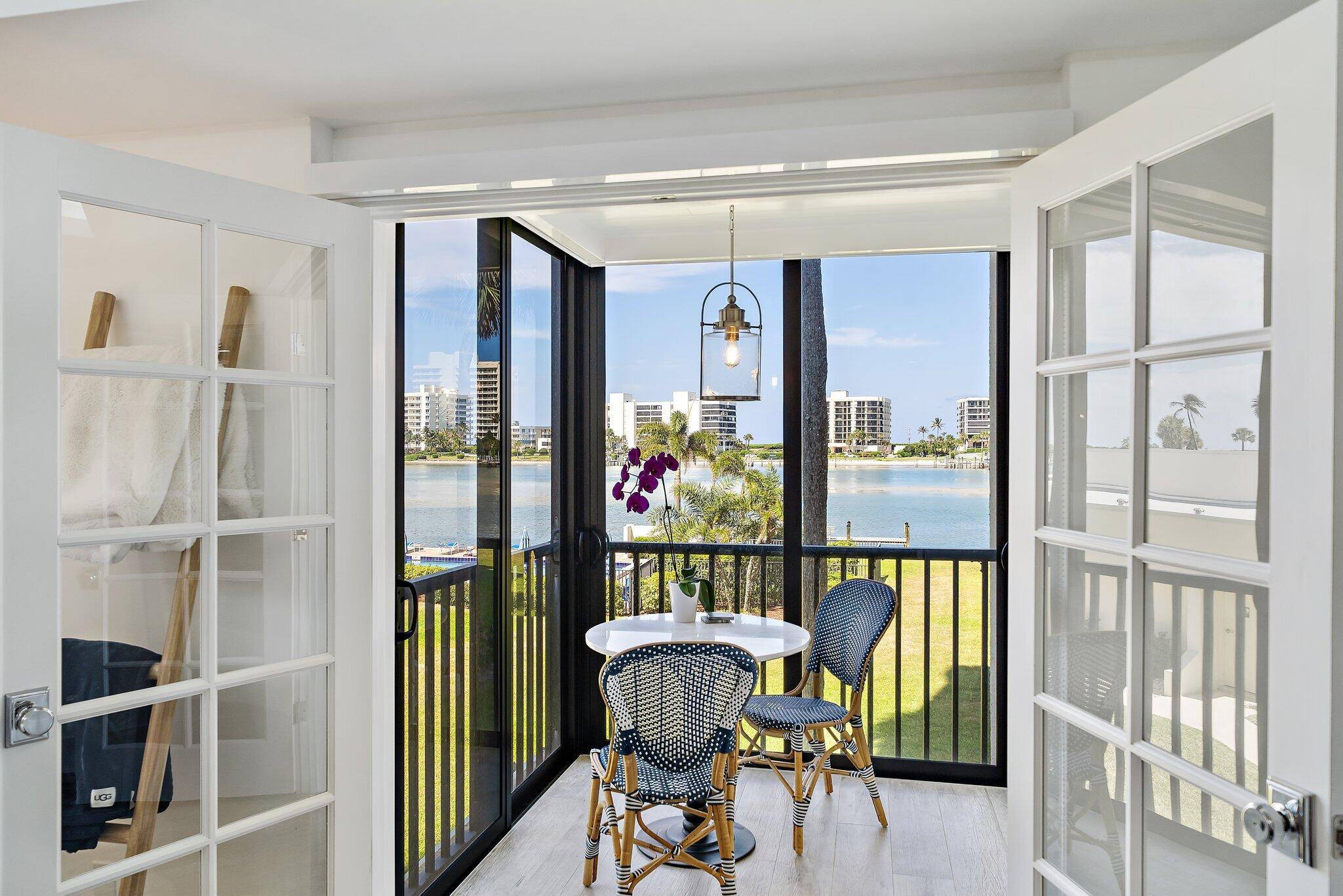 19800 Sandpointe Bay Drive, Unit 210 Jupiter, FL 33469 - Photo 14 of 59 a living room with furniture and a large window