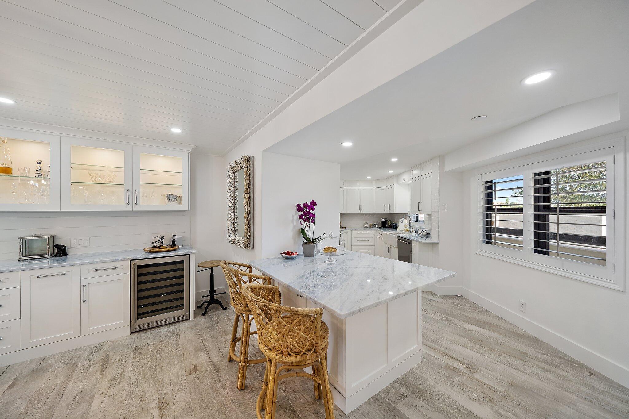 19800 Sandpointe Bay Drive, Unit 210 Jupiter, FL 33469 - Photo 18 of 59 a kitchen with a table and chairs in it