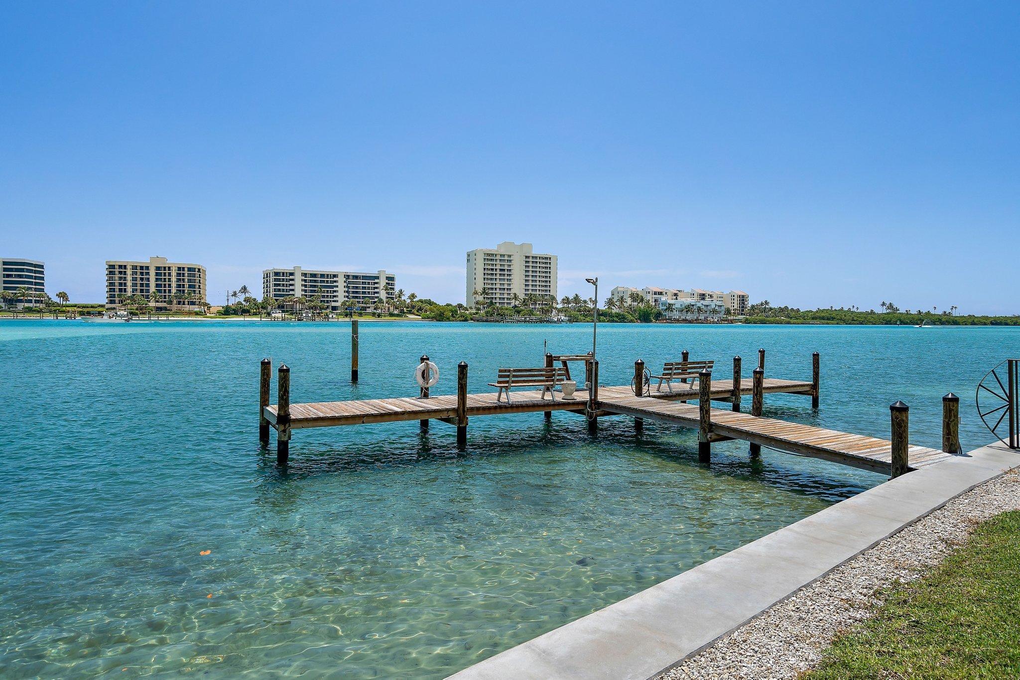 19800 Sandpointe Bay Drive, Unit 210 Jupiter, FL 33469 - Photo 22 of 59 a view of a bench in the middle of a garden