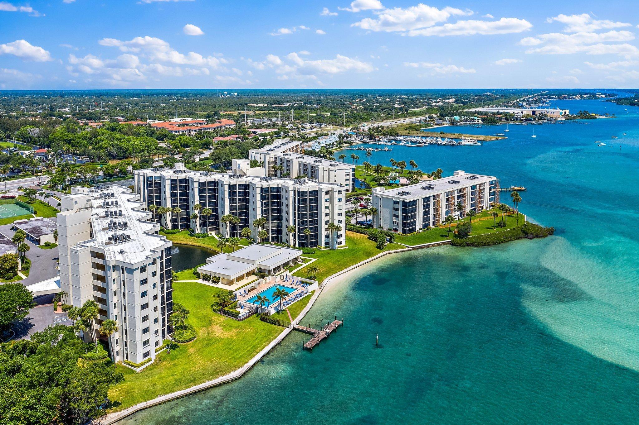 19800 Sandpointe Bay Drive, Unit 210 Jupiter, FL 33469 - Photo 28 of 59 a view of a city with lawn chairs and a big yard