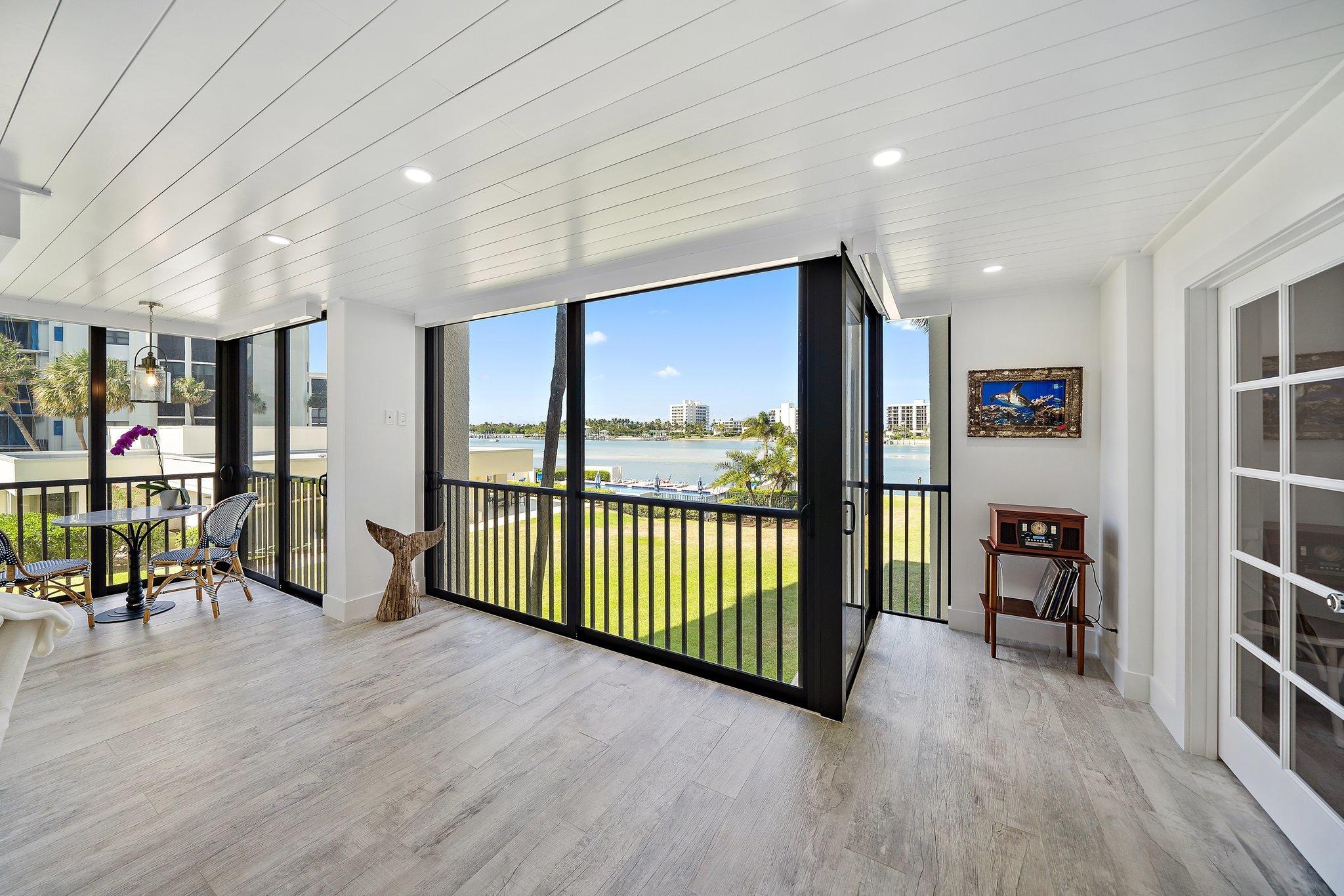 19800 Sandpointe Bay Drive, Unit 210 Jupiter, FL 33469 - Photo 5 of 59 a view of a hallway with furniture and wooden floor
