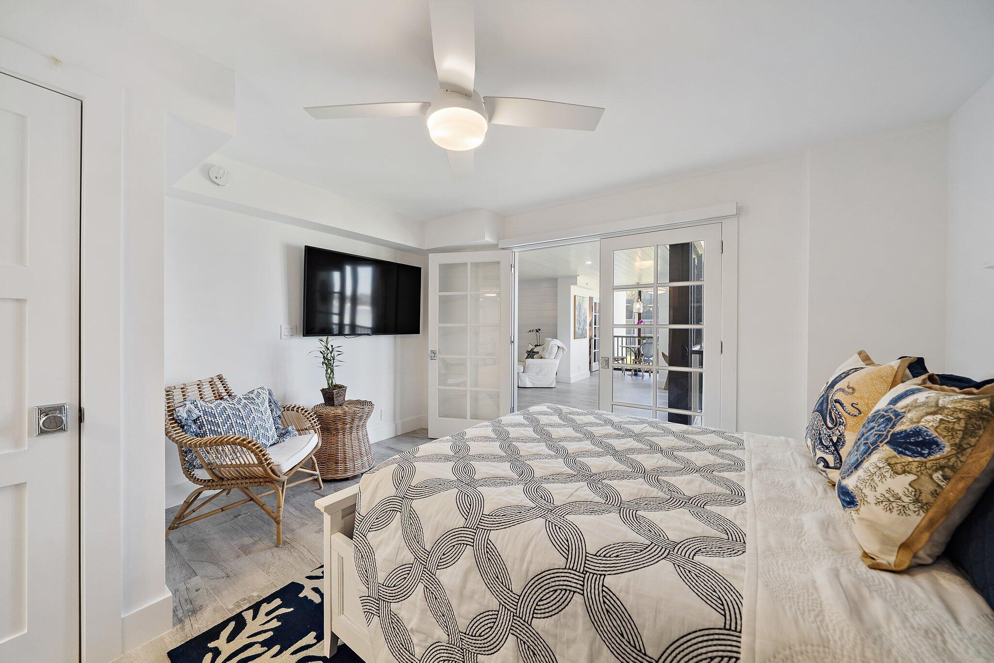 19800 Sandpointe Bay Drive, Unit 210 Jupiter, FL 33469 - Photo 42 of 59 a bedroom with a bed and a television