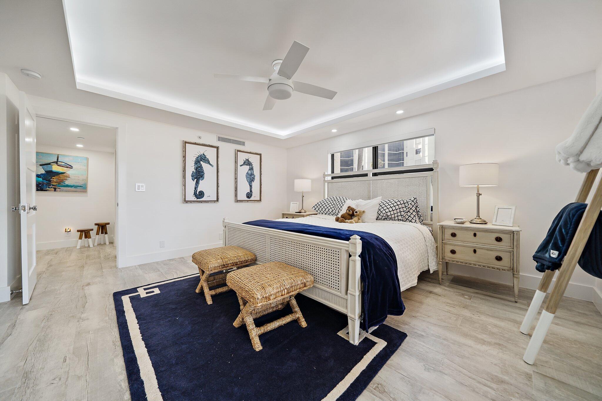 19800 Sandpointe Bay Drive, Unit 210 Jupiter, FL 33469 - Photo 47 of 59 a bedroom with a bed and wooden floor