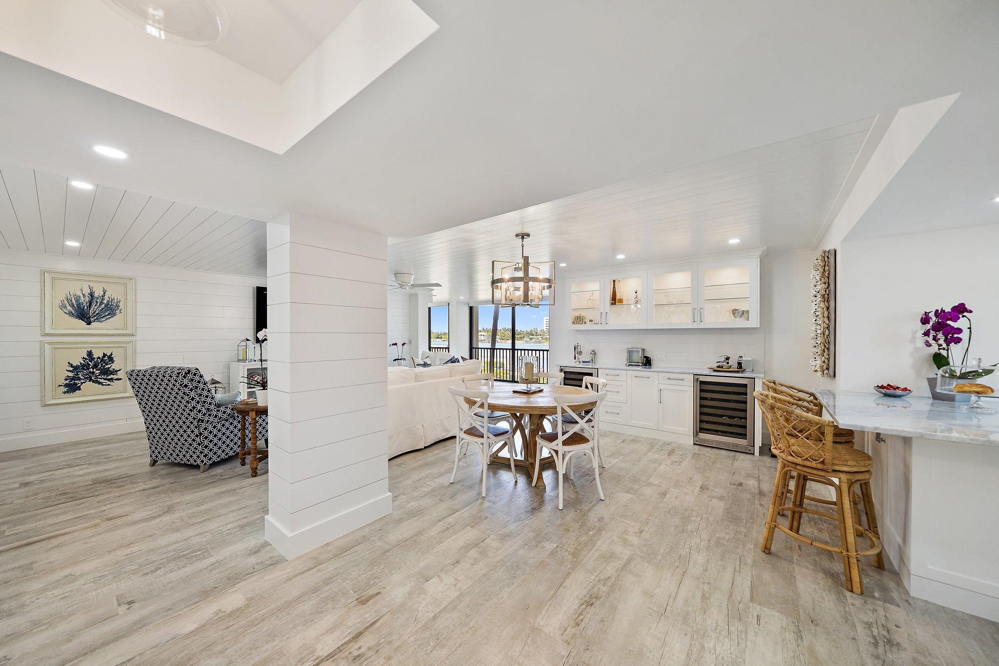 19800 Sandpointe Bay Drive, Unit 210 Jupiter, FL 33469 - Photo 8 of 59 a view of a dining room with furniture and wooden floor