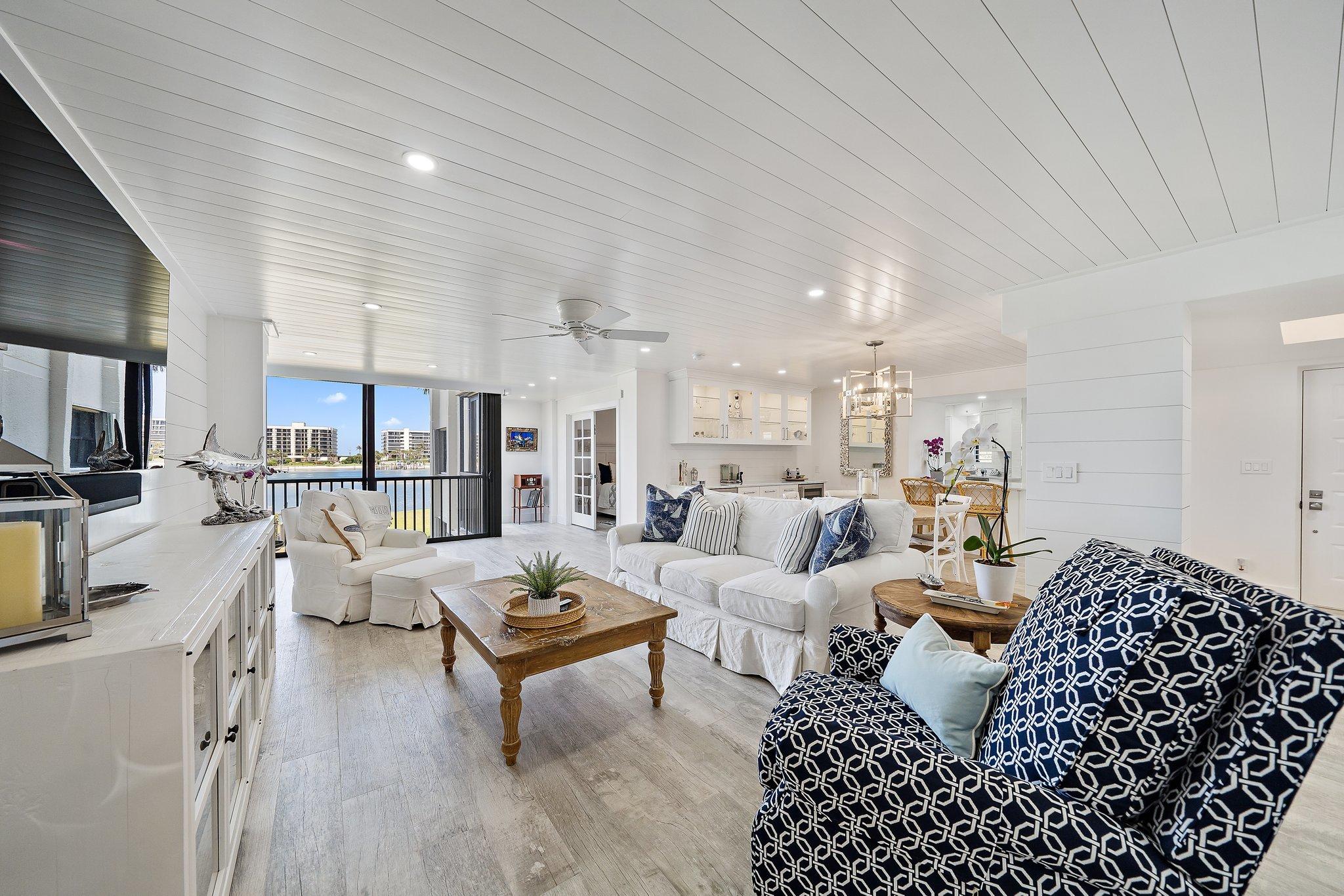 19800 Sandpointe Bay Drive, Unit 210 Jupiter, FL 33469 - Photo 10 of 59 a living room with furniture window and wooden floor