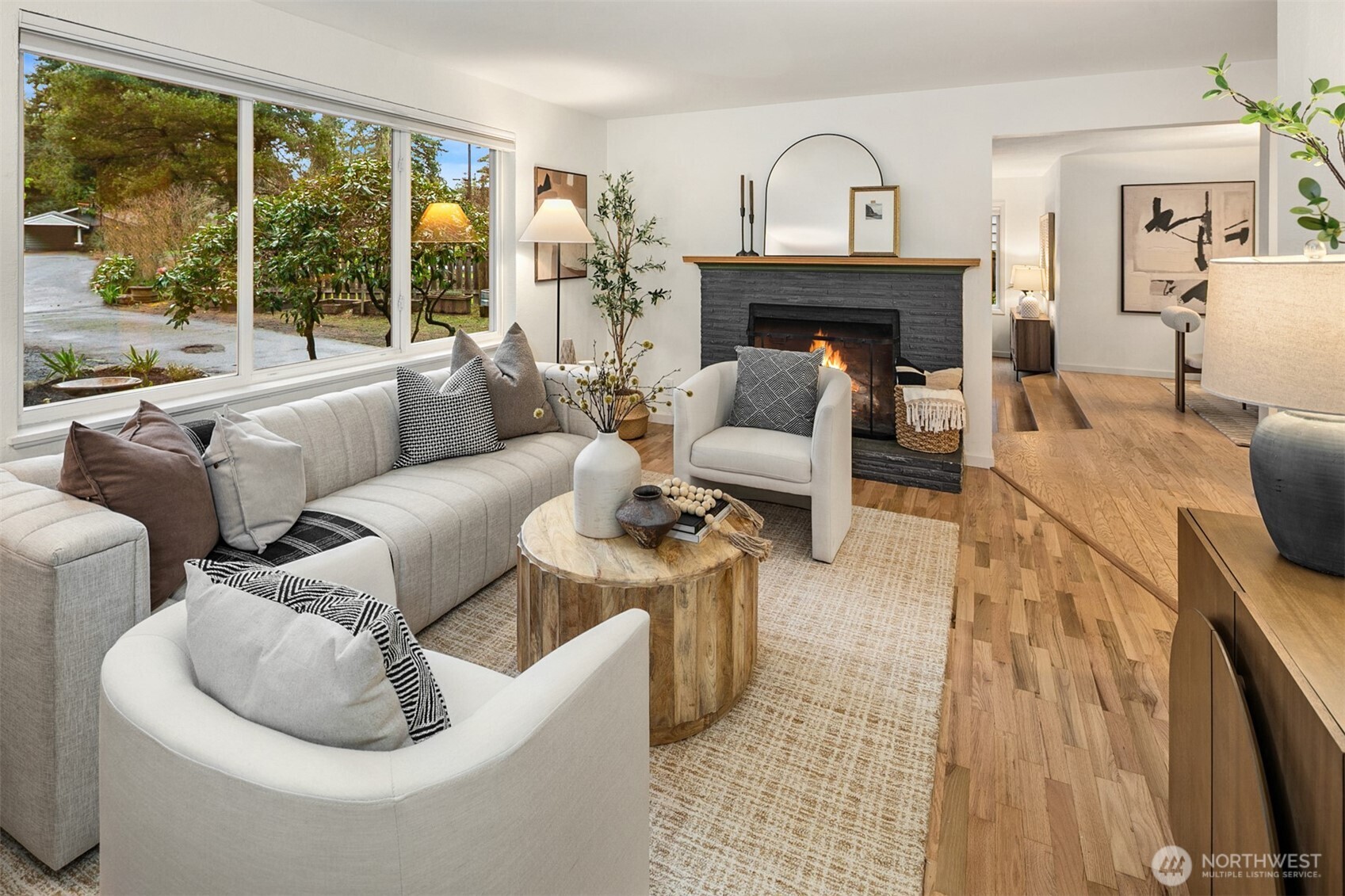 24315 104th Place West Edmonds, WA 98020 - Photo 4 of 29 a living room with furniture a fireplace and a floor to ceiling window