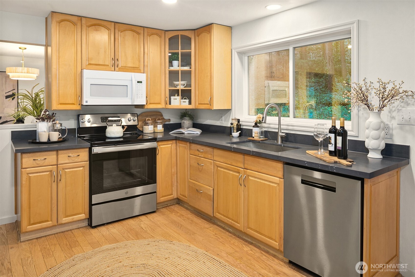 24315 104th Place West Edmonds, WA 98020 - Photo 7 of 29 a kitchen with stainless steel appliances granite countertop a sink stove and cabinets