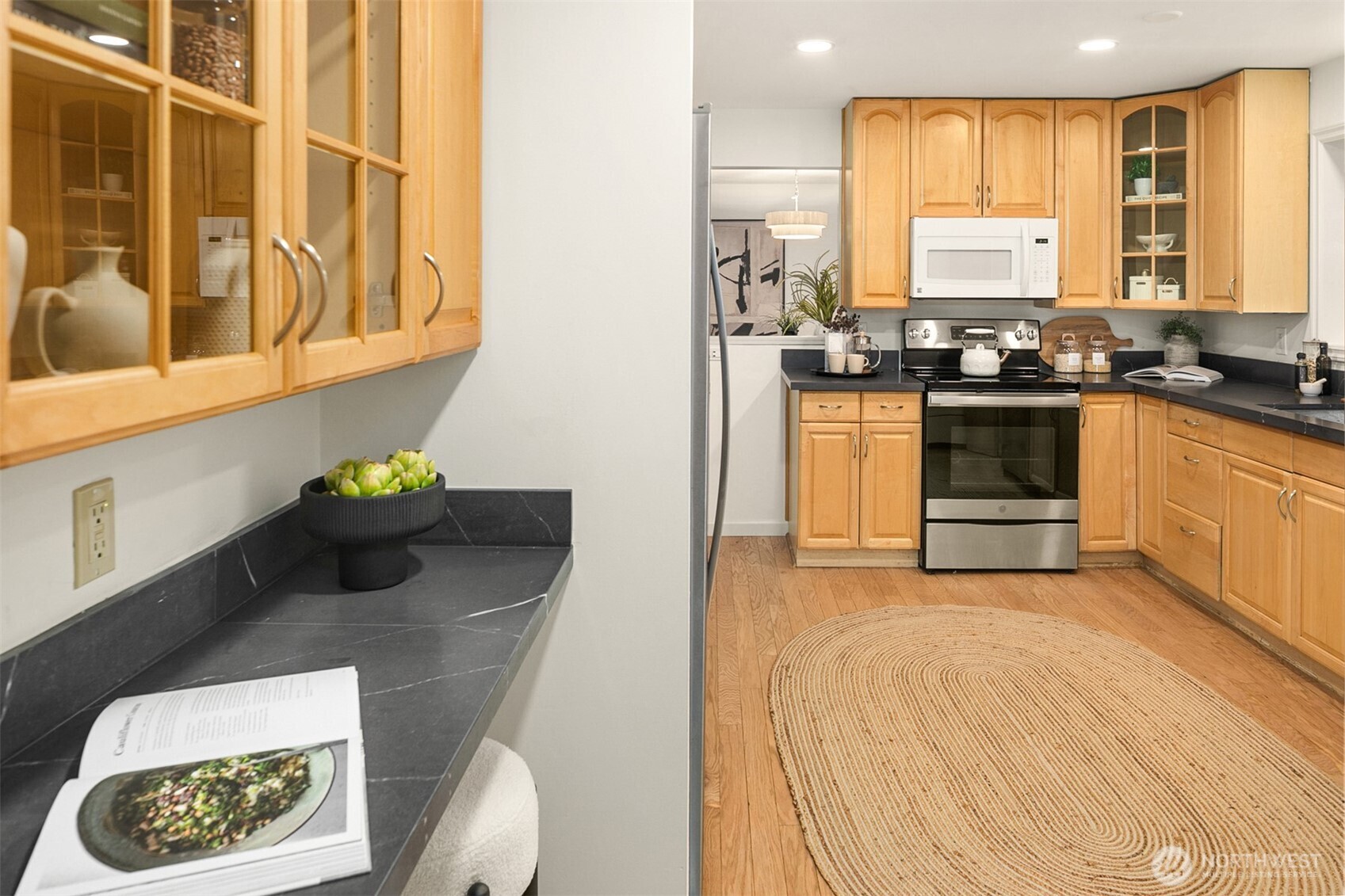 24315 104th Place West Edmonds, WA 98020 - Photo 10 of 29 a kitchen with stainless steel appliances white cabinets and wooden floor