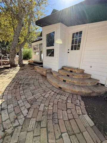 a view of a backyard with hardwood area