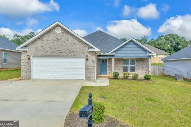 a front view of a house with a garden and patio