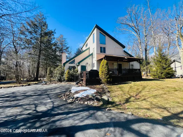 a view of a house with snow on the road