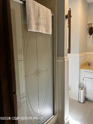 a bathroom with a toilet a sink and mirror