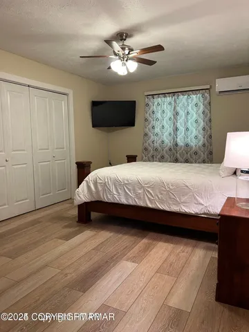 a bathroom with a toilet sink a mirror and shower