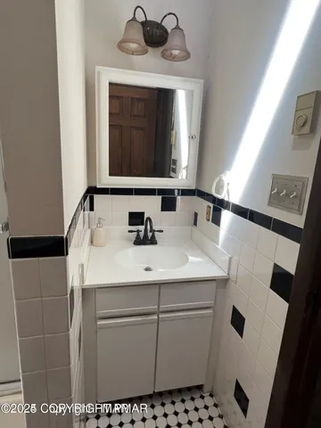 a view of staircase with railing and white walls