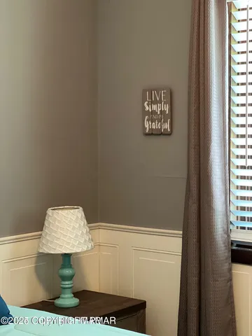 a view of bedroom with furniture and window