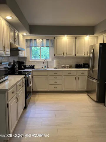 a stove top oven sitting inside of a kitchen