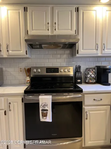 a big room with wooden floor and windows