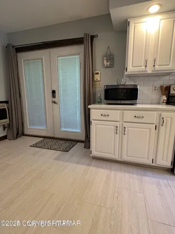 a living room with a table and chairs