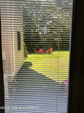 a view of a two chairs in the patio
