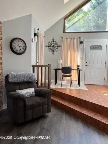 a living room with furniture and a large window