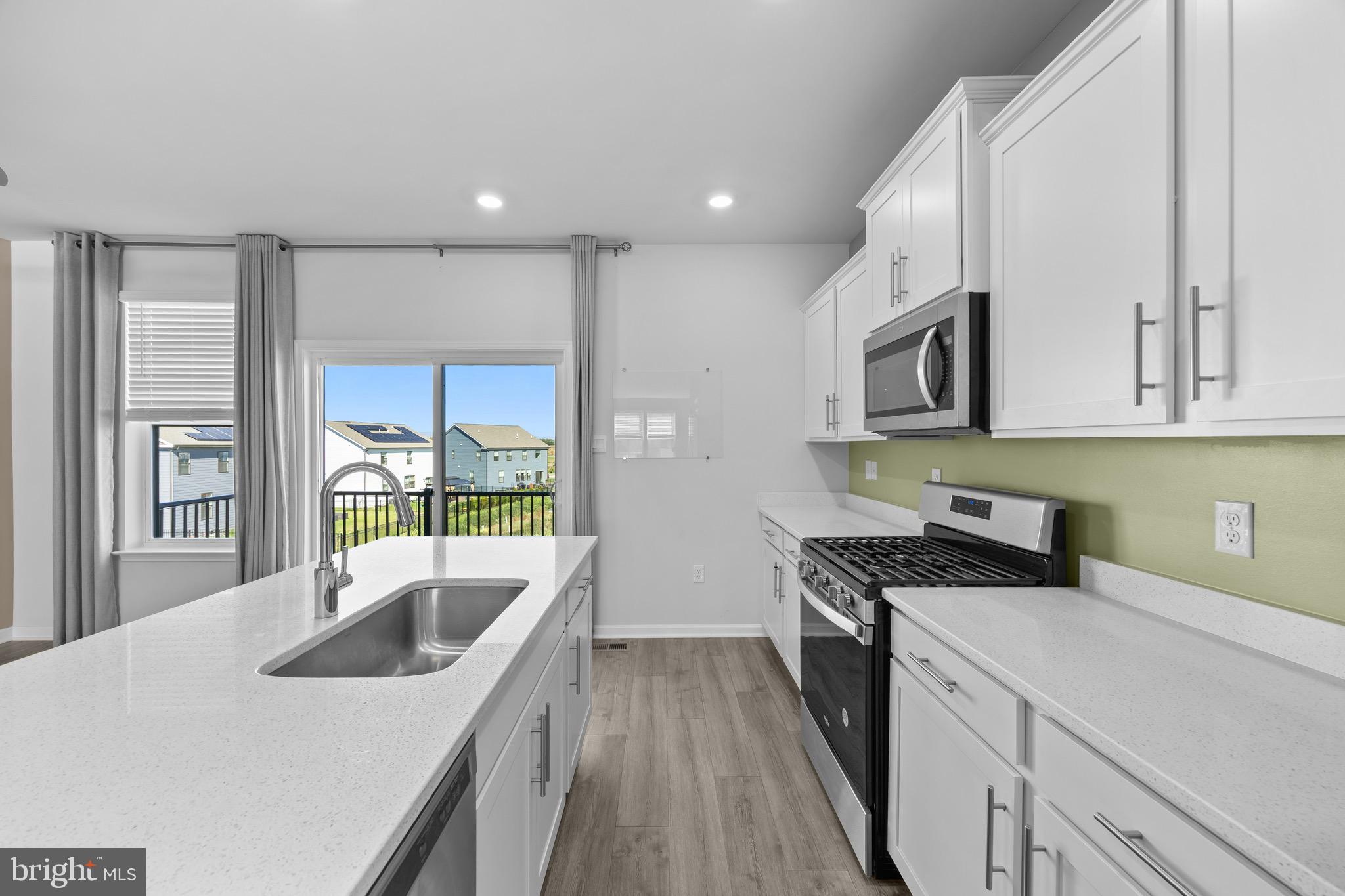 813 Bond Street Frederick, MD 21701 - Photo 13 of 46 a kitchen with stainless steel appliances granite countertop a sink a stove and cabinets