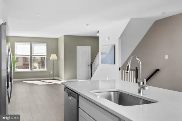 a kitchen with a sink and a large mirror