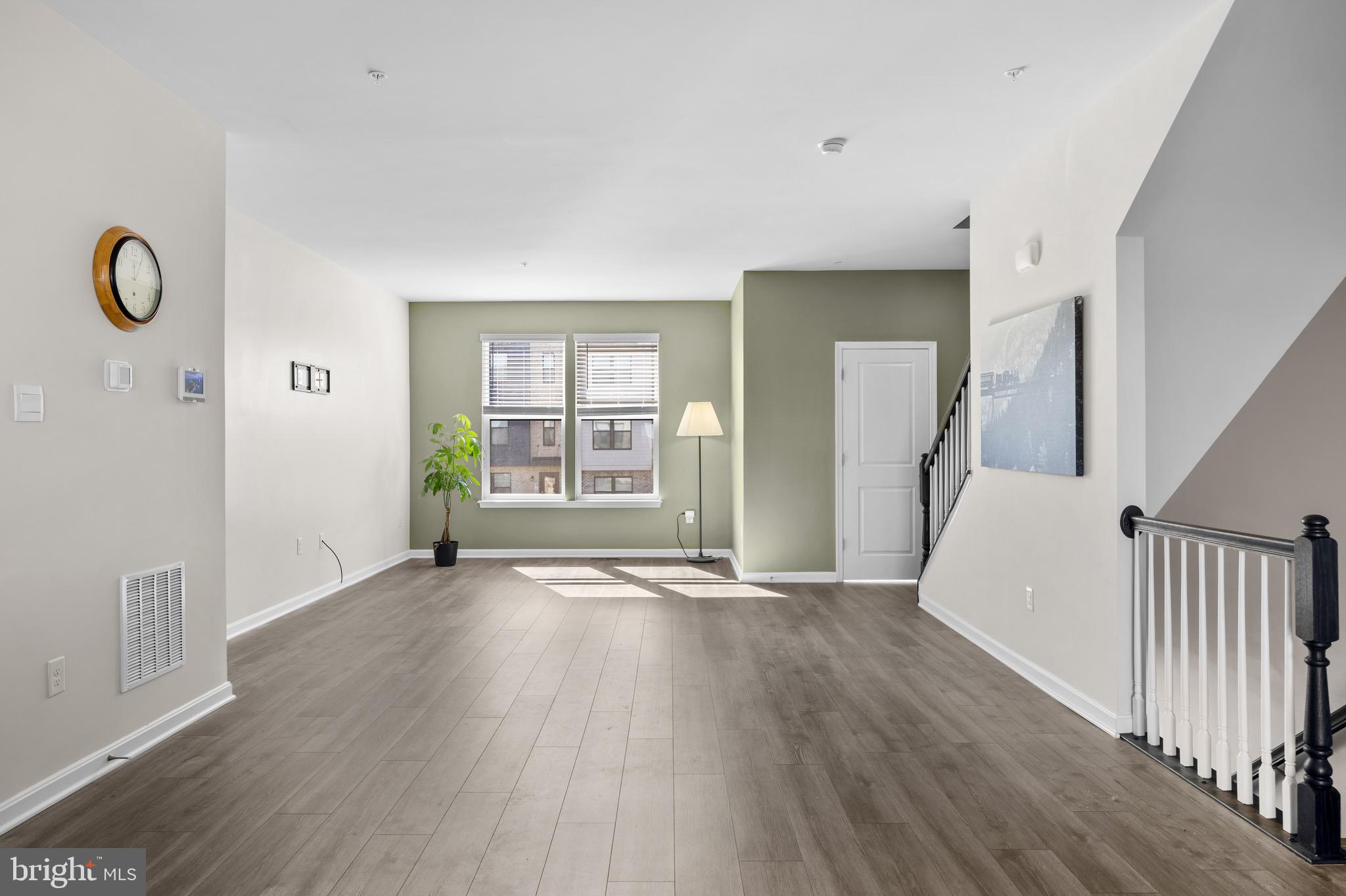 813 Bond Street Frederick, MD 21701 - Photo 19 of 46 an empty room with wooden floor and windows