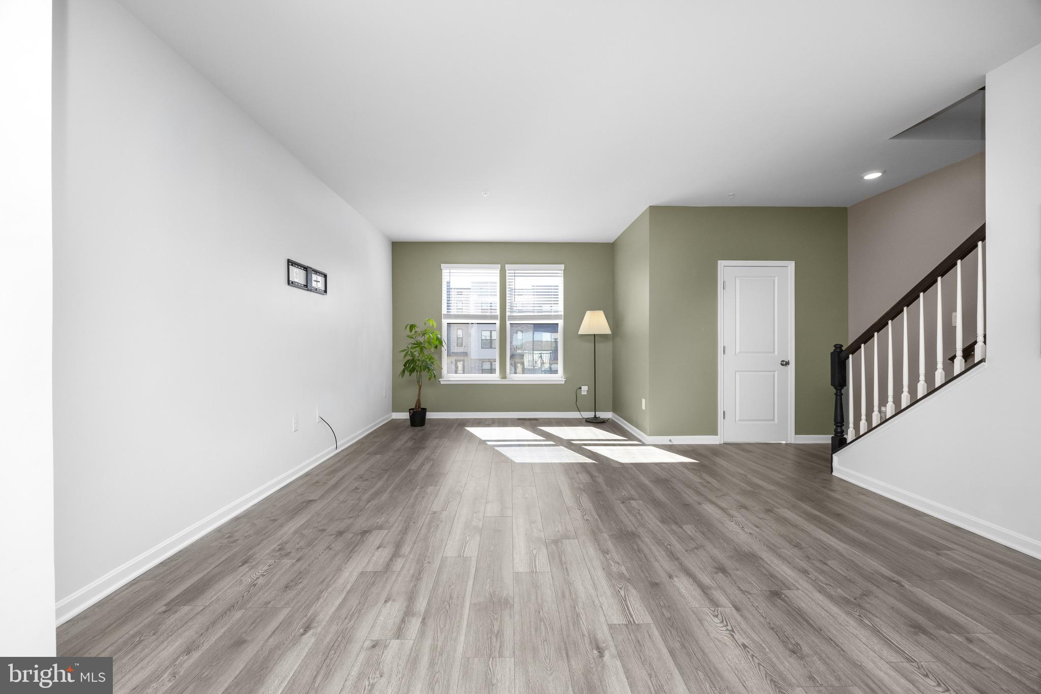 813 Bond Street Frederick, MD 21701 - Photo 20 of 46 a view of an empty room with wooden floor and a window