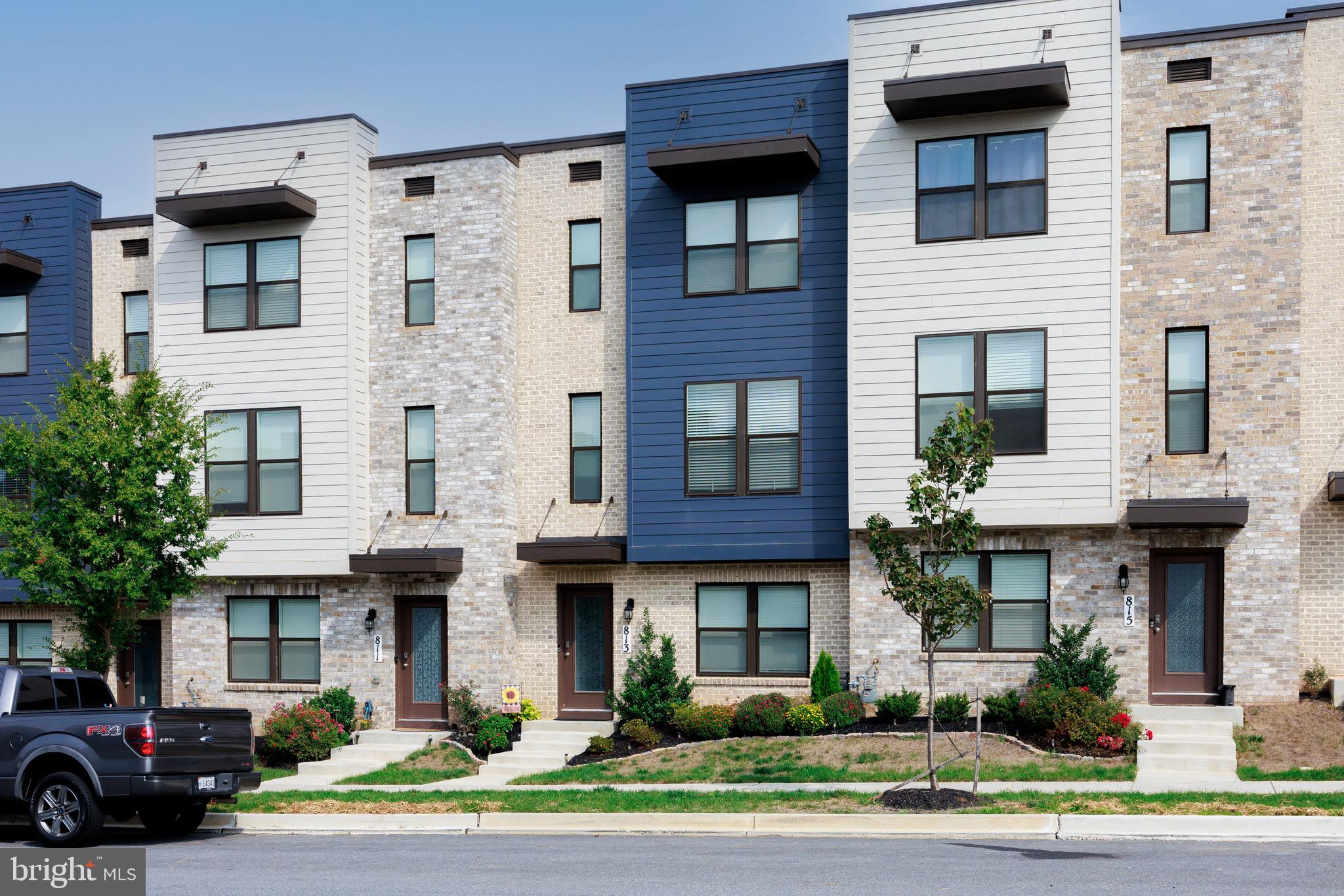 813 Bond Street Frederick, MD 21701 - Photo 2 of 46 a front view of a building with a garden and plants