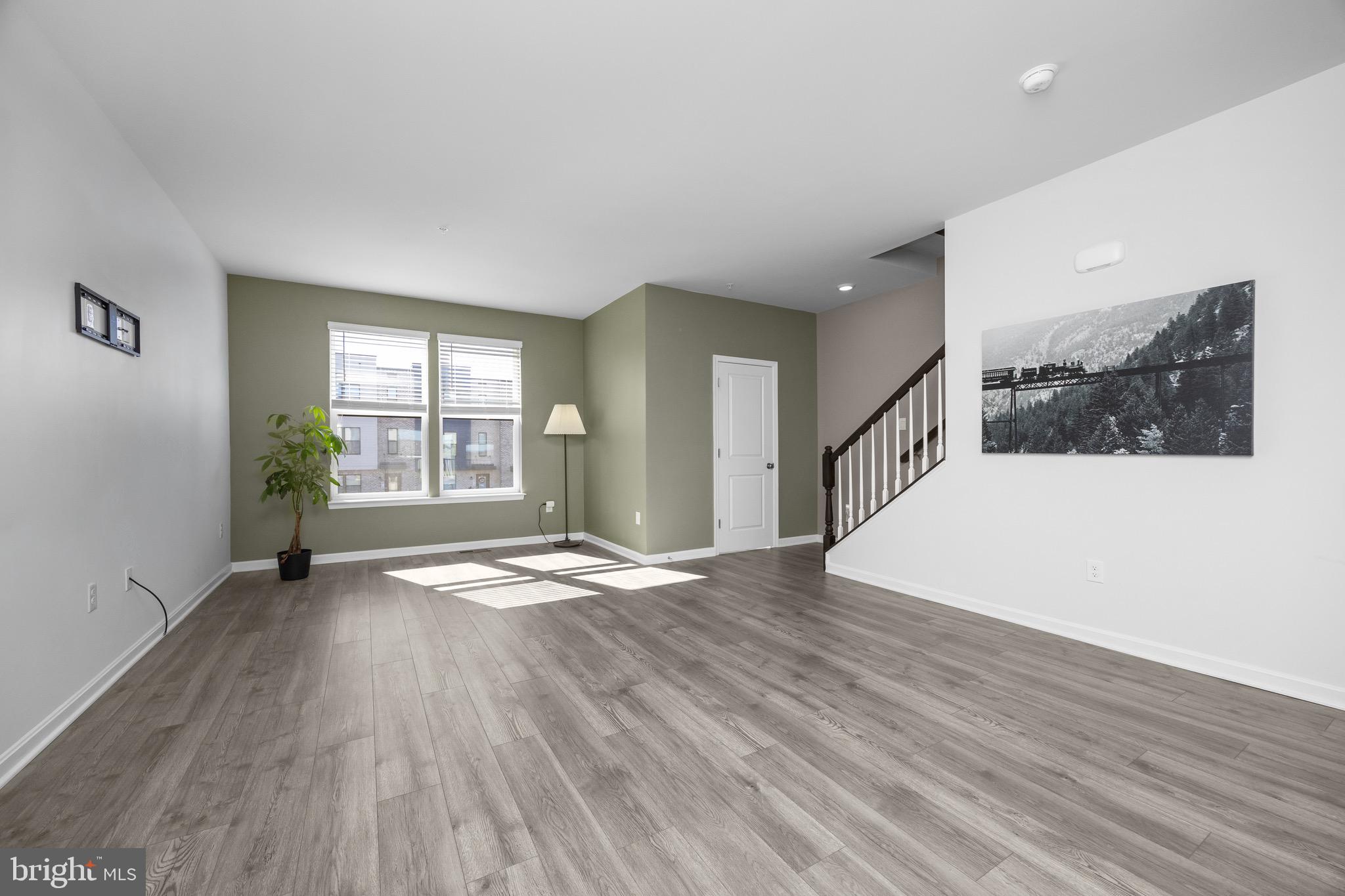 813 Bond Street Frederick, MD 21701 - Photo 22 of 46 a view of an empty room with wooden floor and a window