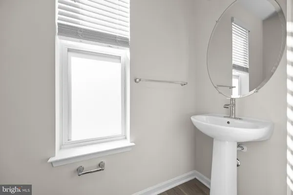 a bathroom with a sink a mirror and a window