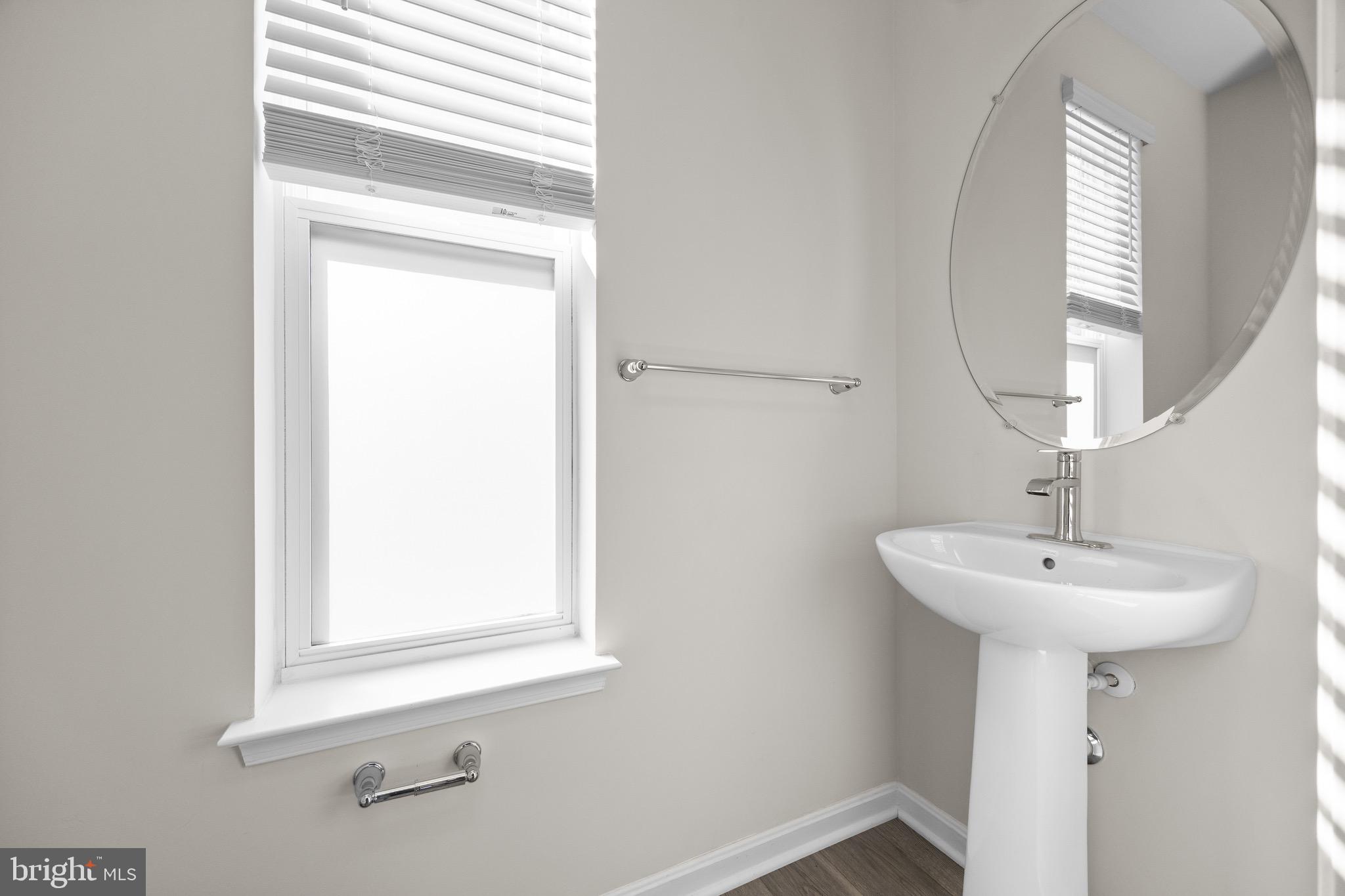 813 Bond Street Frederick, MD 21701 - Photo 25 of 46 a bathroom with a sink a mirror and a window