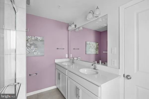 a bathroom with a sink vanity granite and a mirror