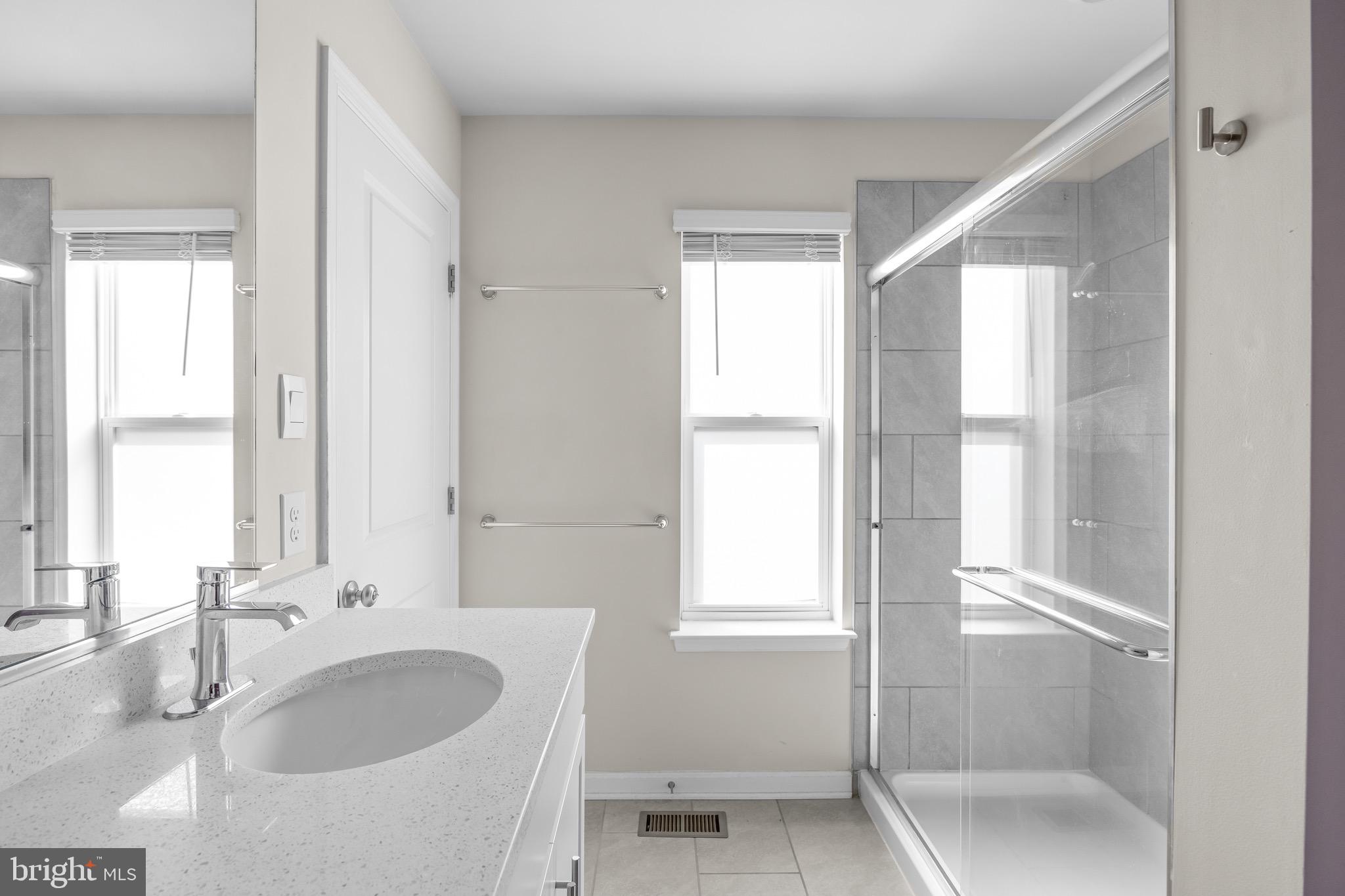 813 Bond Street Frederick, MD 21701 - Photo 31 of 46 a bathroom with a granite countertop sink and a large mirror
