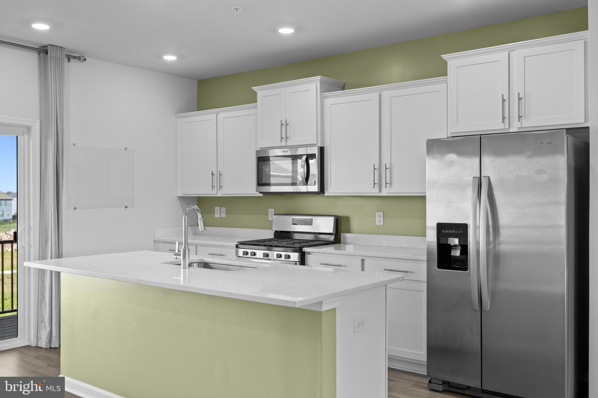 813 Bond Street Frederick, MD 21701 - Photo 10 of 46 a kitchen with stainless steel appliances a refrigerator a sink a stove a microwave and island