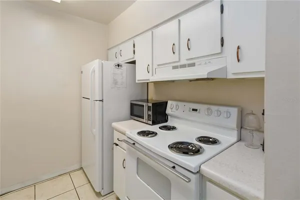 a kitchen with a stove and a refrigerator