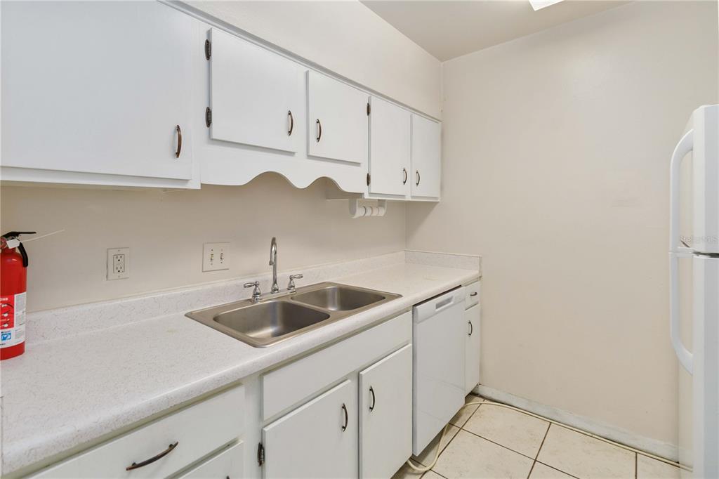 2500 Lee Road, Unit 244 Winter Park, FL 32789 - Photo 14 of 26 a kitchen with white cabinets and a sink