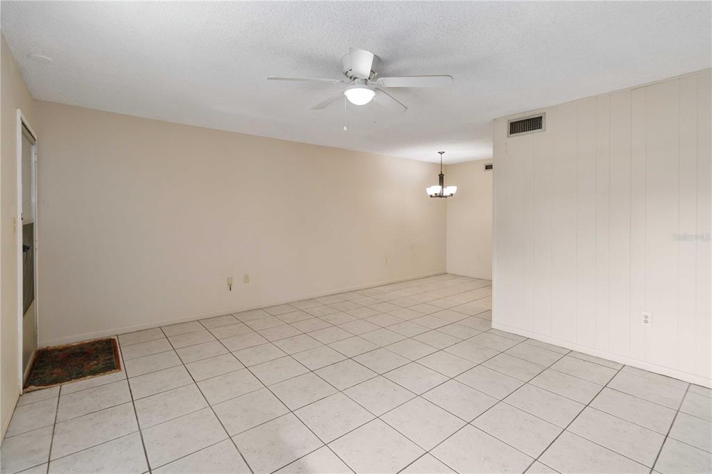 2500 Lee Road, Unit 244 Winter Park, FL 32789 - Photo 9 of 26 wooden floor in an empty room with a white cabinet