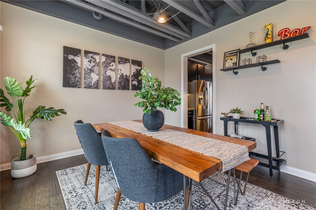 407 Brownstone Row Springboro, OH 45066 - Photo 8 of 54 This inviting dining area features dark wood flooring, and exposed ceiling beams.