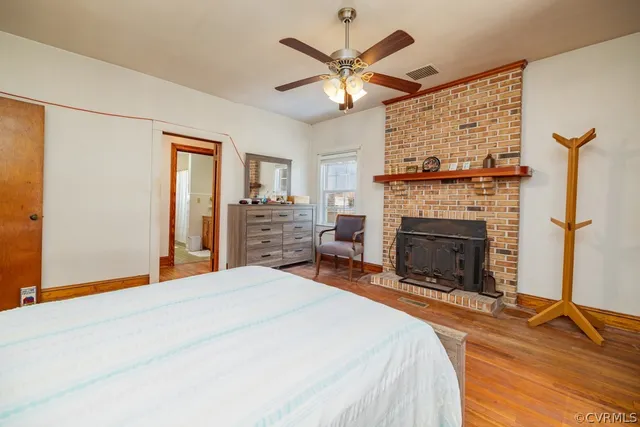 a bedroom with a bed and a fireplace