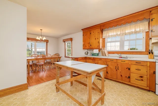 a room with table chairs and windows